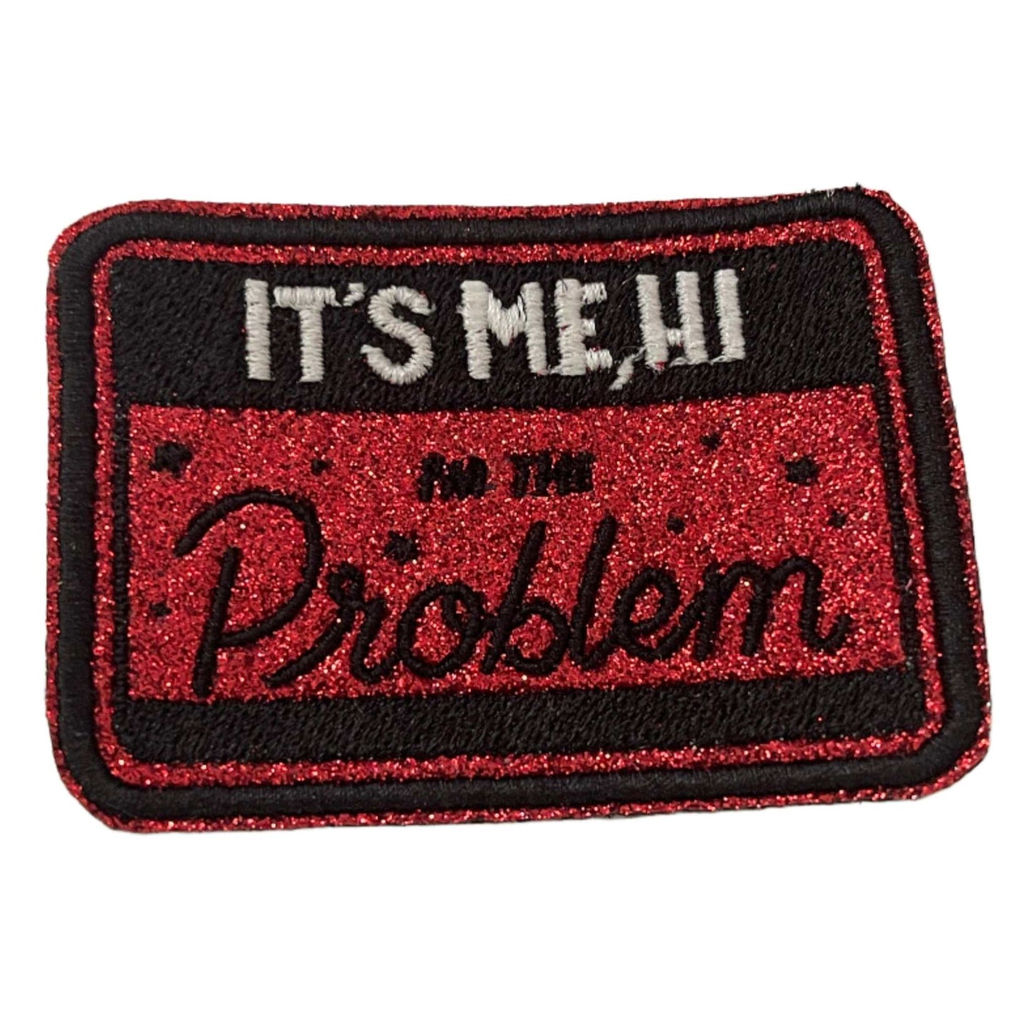 Iron-on patch with "It's Me, Hi" lyrics from Taylor Swift's "Anti-Hero" in red and black design.