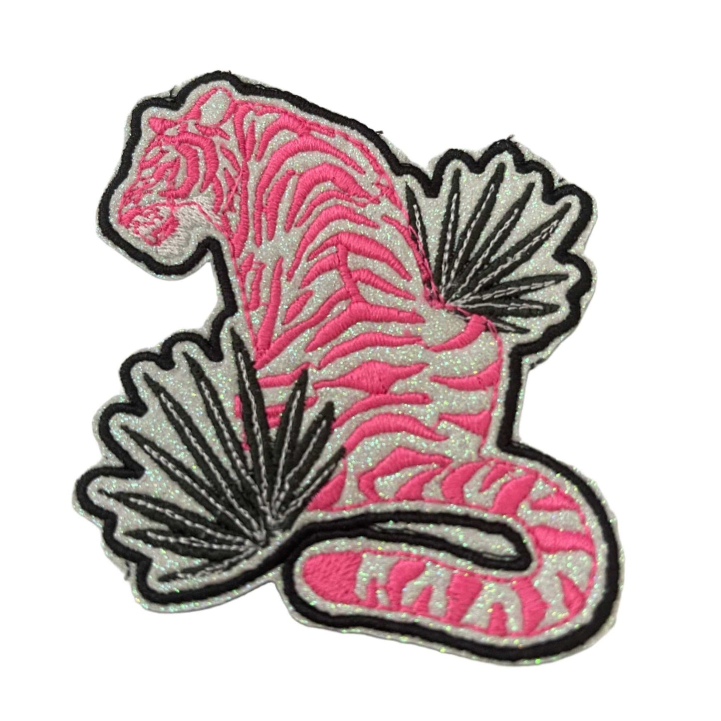 Neon Pink Tiger patch with dark green leaves and black outline on white glitter vinyl.