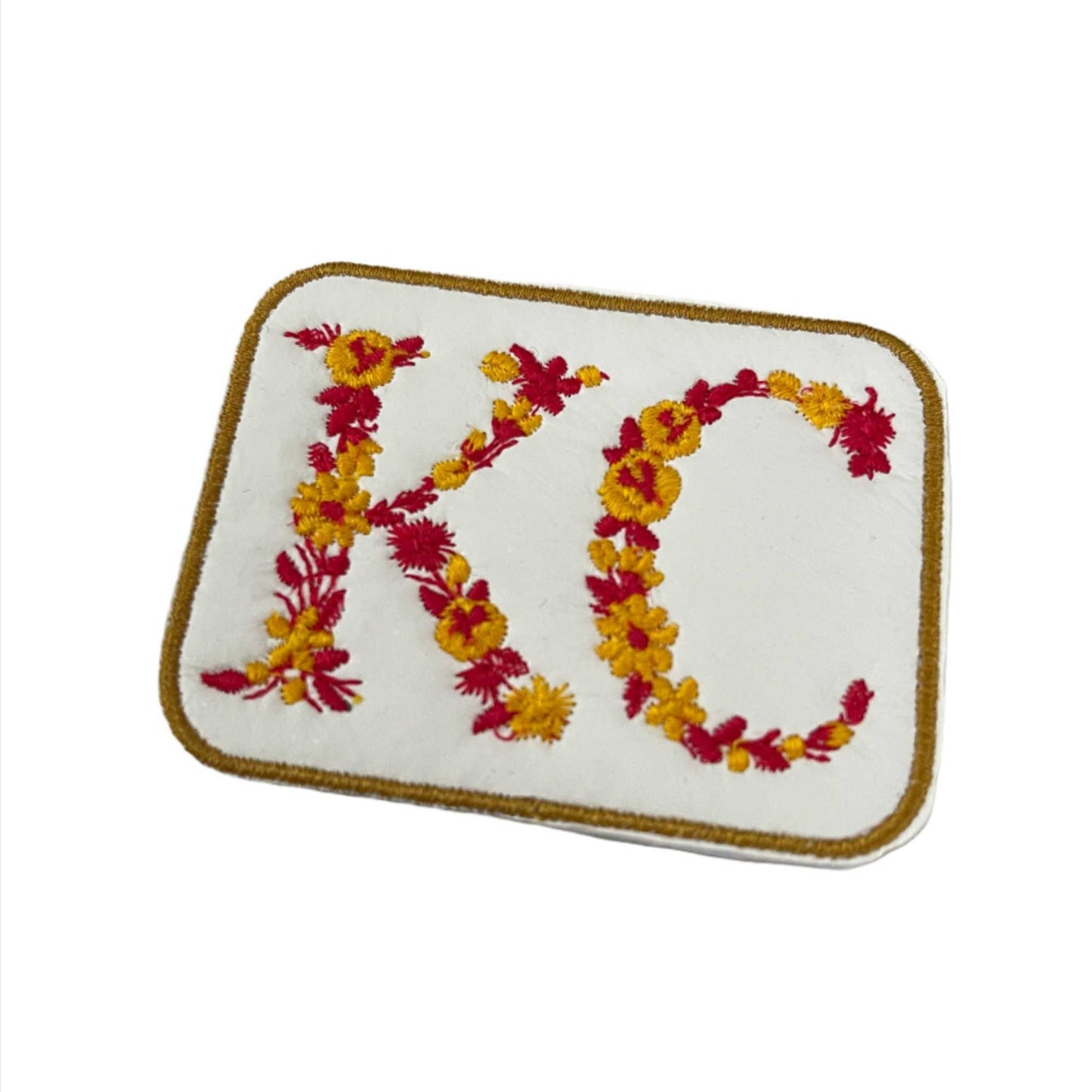 Floral KC iron-on patch with vibrant flower design.
