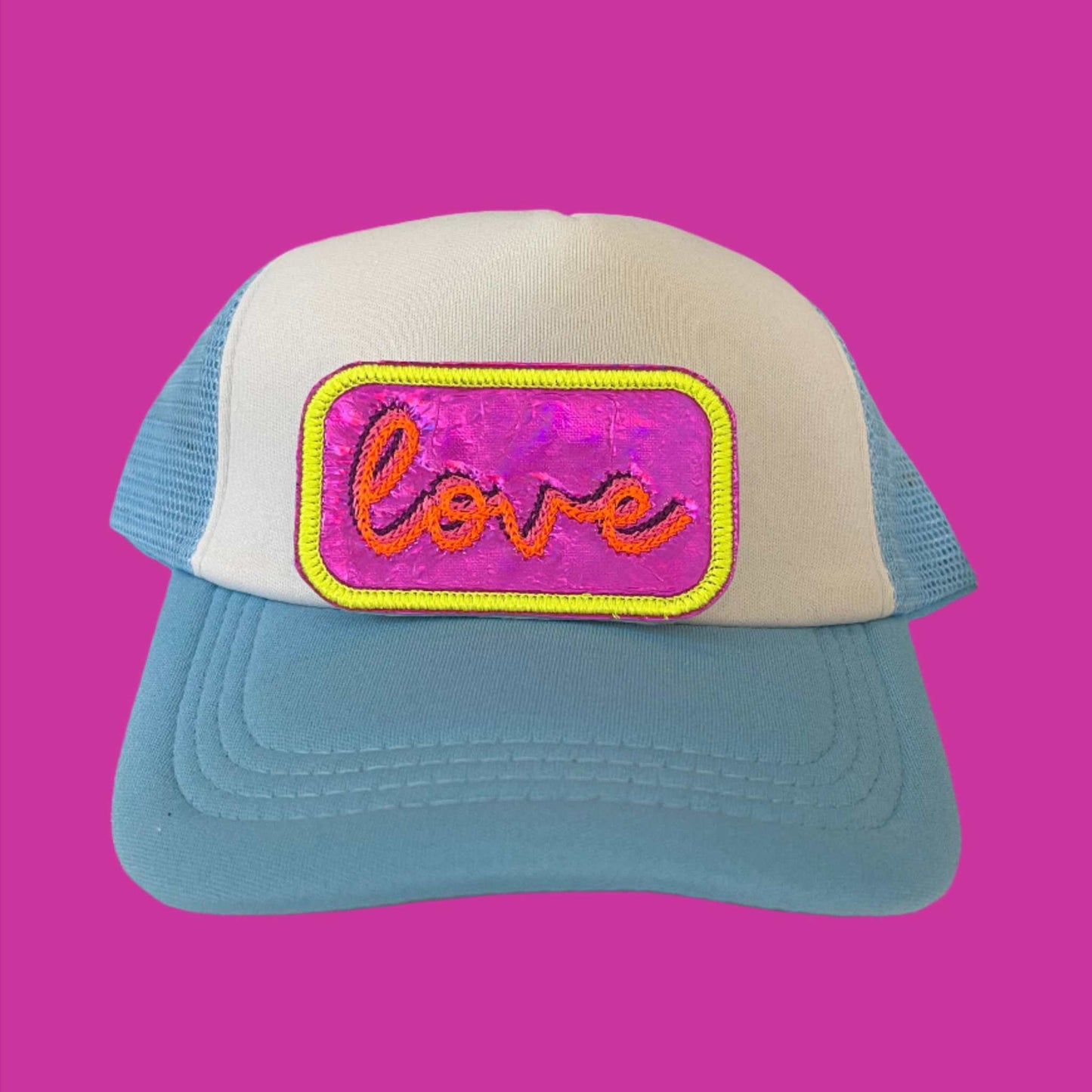 Neon iron-on patch featuring the word "love" in vibrant colors, set against a shiny, eye-catching background, showcasing a bold and retro aesthetic.