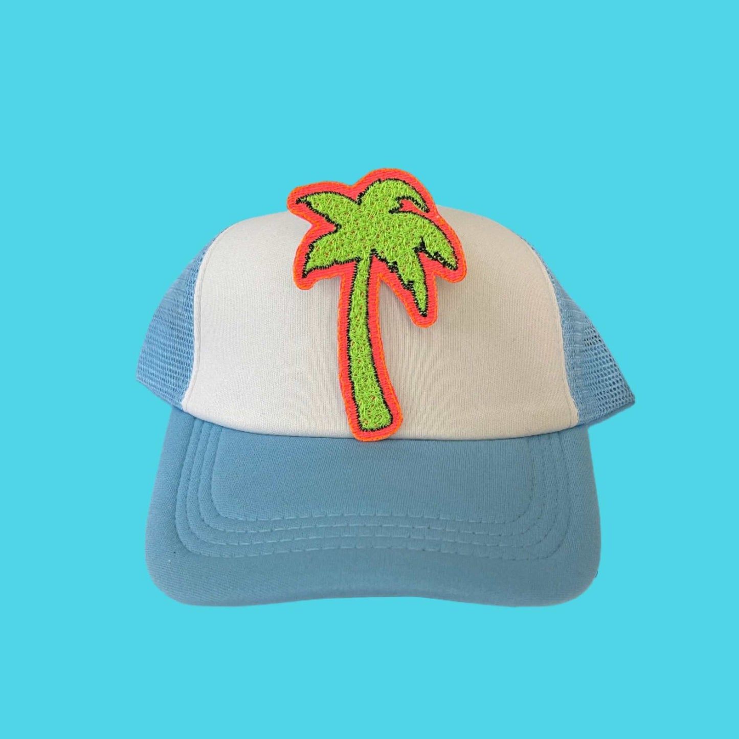 Close-up of a neon palm tree embroidered patch with green and pink detailing, perfect for customizing hats and other accessories.