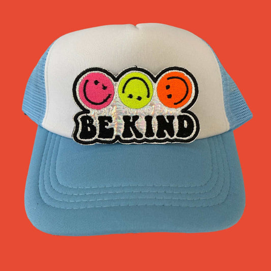 Iron-on patch featuring three smiley faces in neon pink, neon yellow, and neon orange with the phrase "BE KIND" on a holographic silver background.