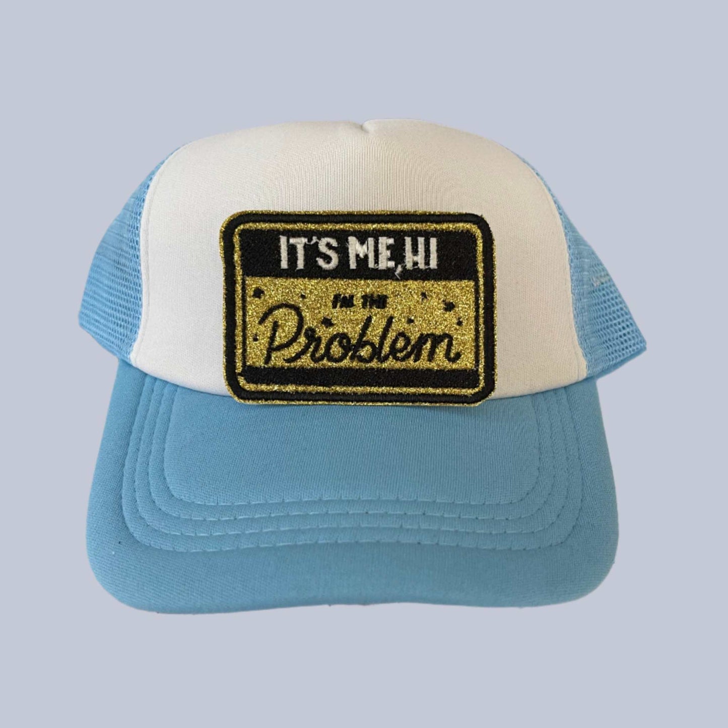 Iron-on patch featuring the phrase "IT'S ME, HI I'M THE PROBLEM" in block and cursive lettering on a glittery gold background with a black outline.