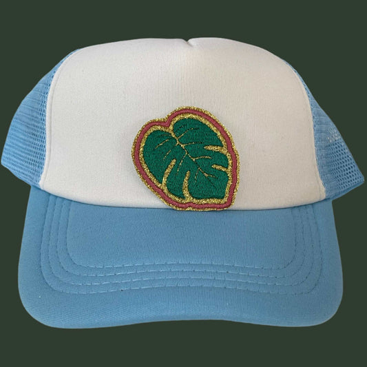 Close-up of a trendy Monstera Leaf embroidered patch with intricate green and gold details, perfect for customizing hats and other accessories.