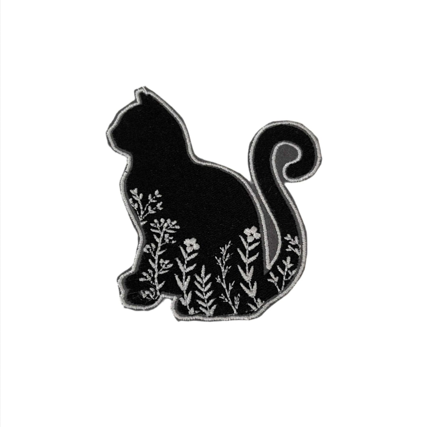 Floral cat embroidered patch with black silhouette and white floral design.