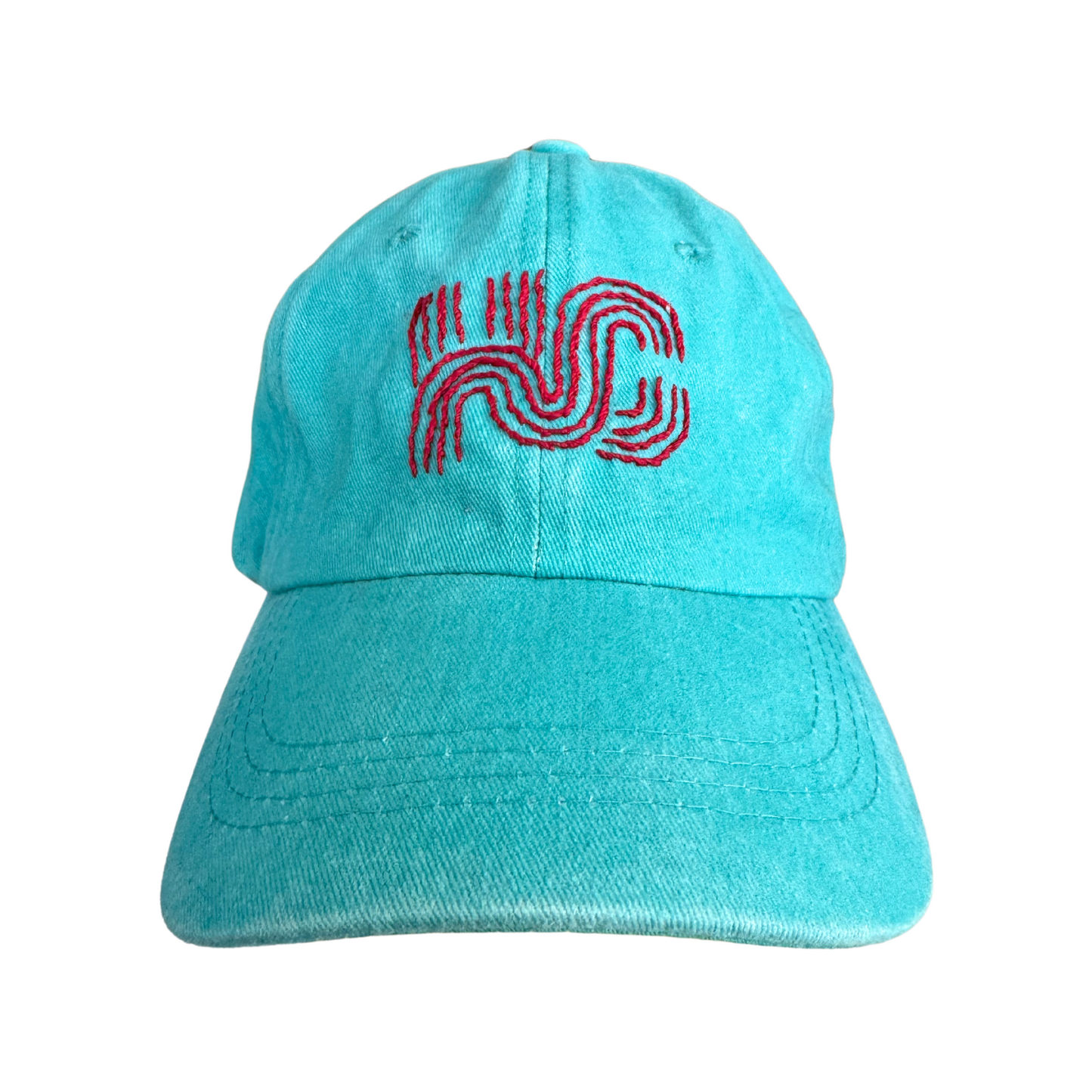 Hand-embroidered KC Current colors hat with original Milkweed Baby KC logo on teal background.