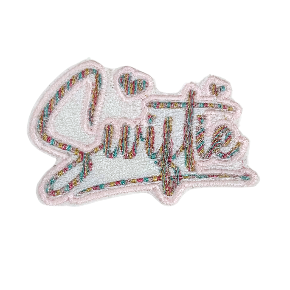 Handmade Swiftie patch featuring colorful embroidery on white fabric.
