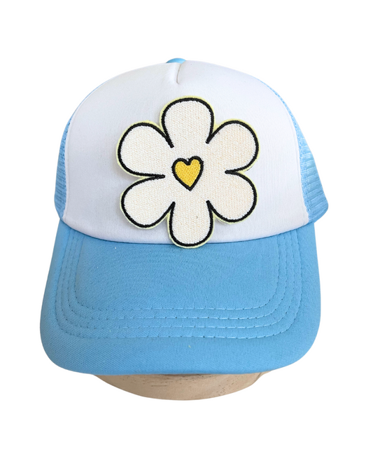 Close-up of a handmade retro flower heart patch with a yellow heart center.