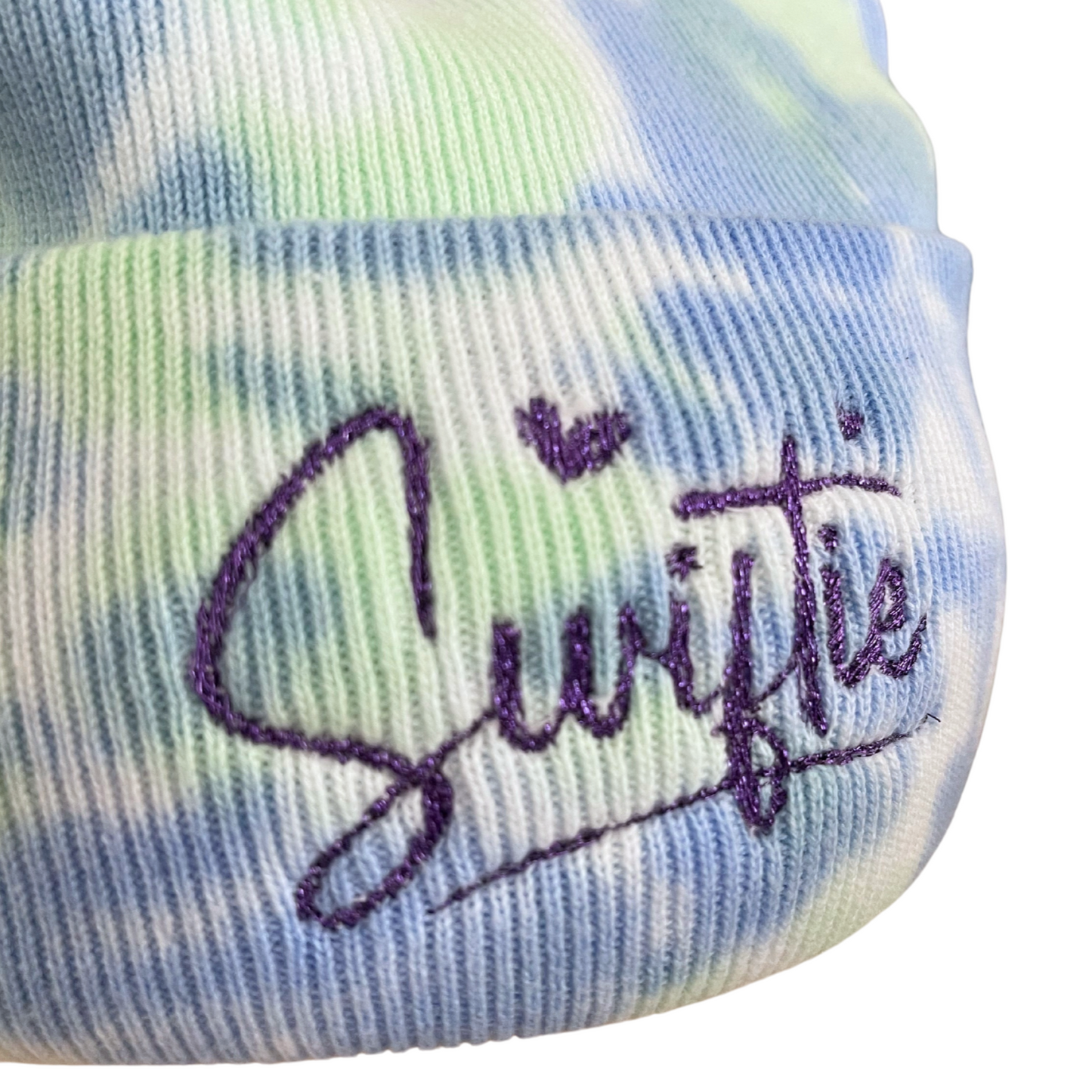 Purple metallic "Swiftie" embroidered on blue and green tie-dye beanie