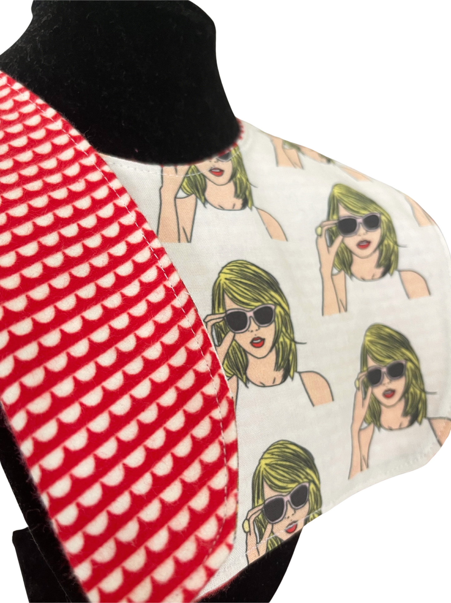 Reversible bib with pop art design featuring Taylor Swift wearing sunglasses.