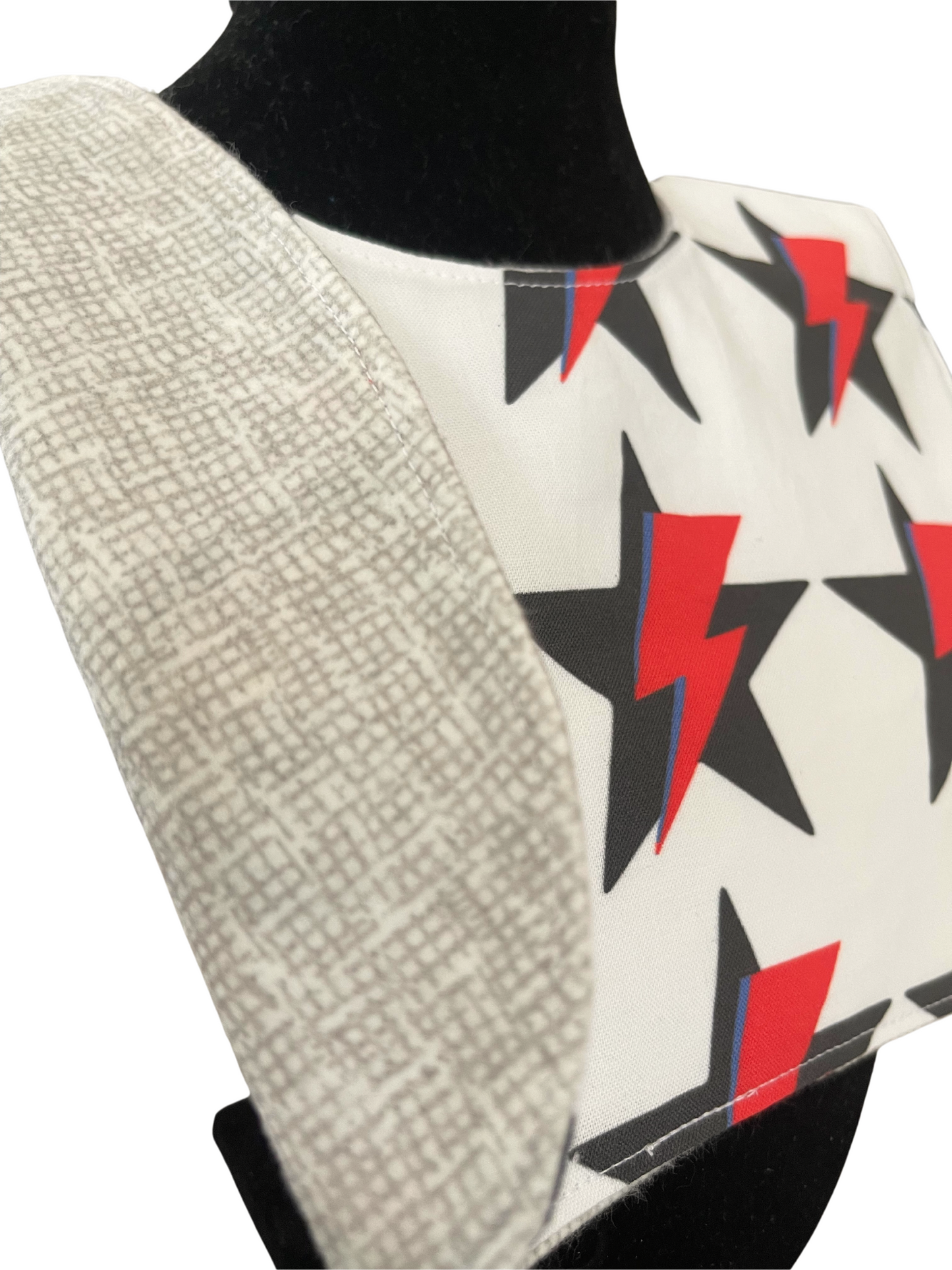 Reversible bib with Ziggy Stardust inspired star and lightning bolt design.