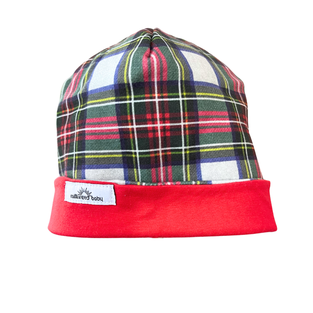 Handcrafted reversible organic cotton baby beanie, festive plaid with red trim, 0-3 months.