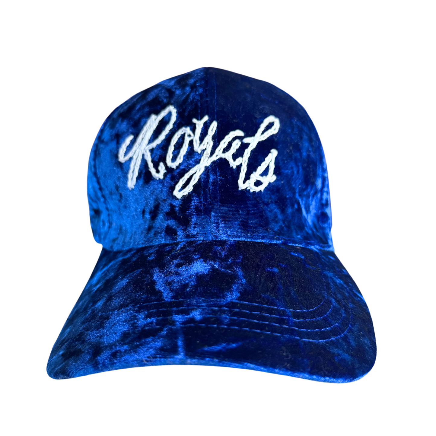 Hand-embroidered "Royals" text on a crushed velvet blue hat.