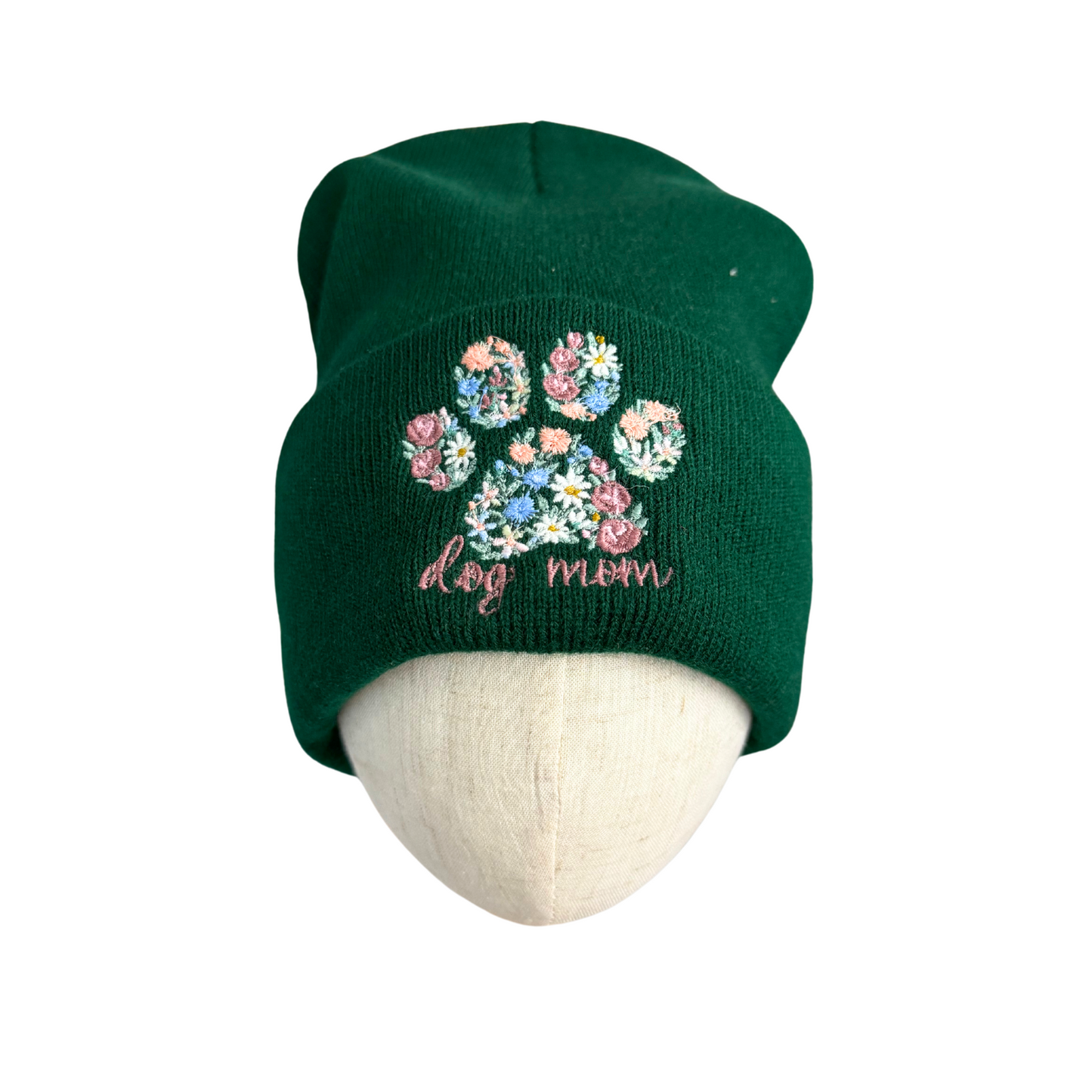 Adult green knit beanie with embroidered floral paw print and "dog mom" text.