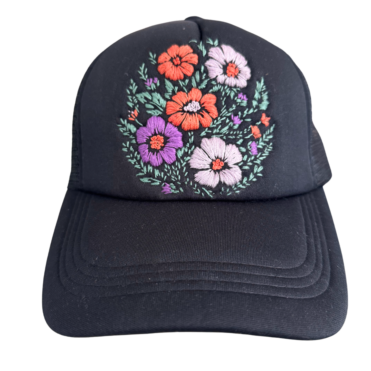 Black floral bouquet hat with hand-embroidered flower design on black background.