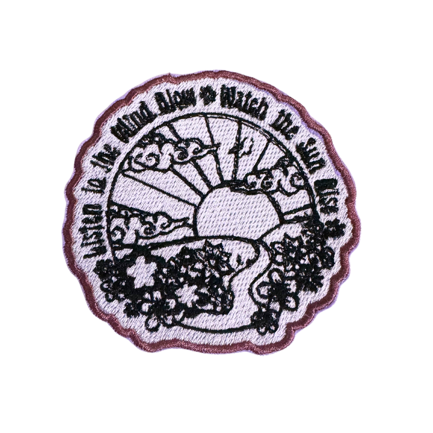 Fleetwood Mac inspired iron-on patch with sun, winding path, and floral details.