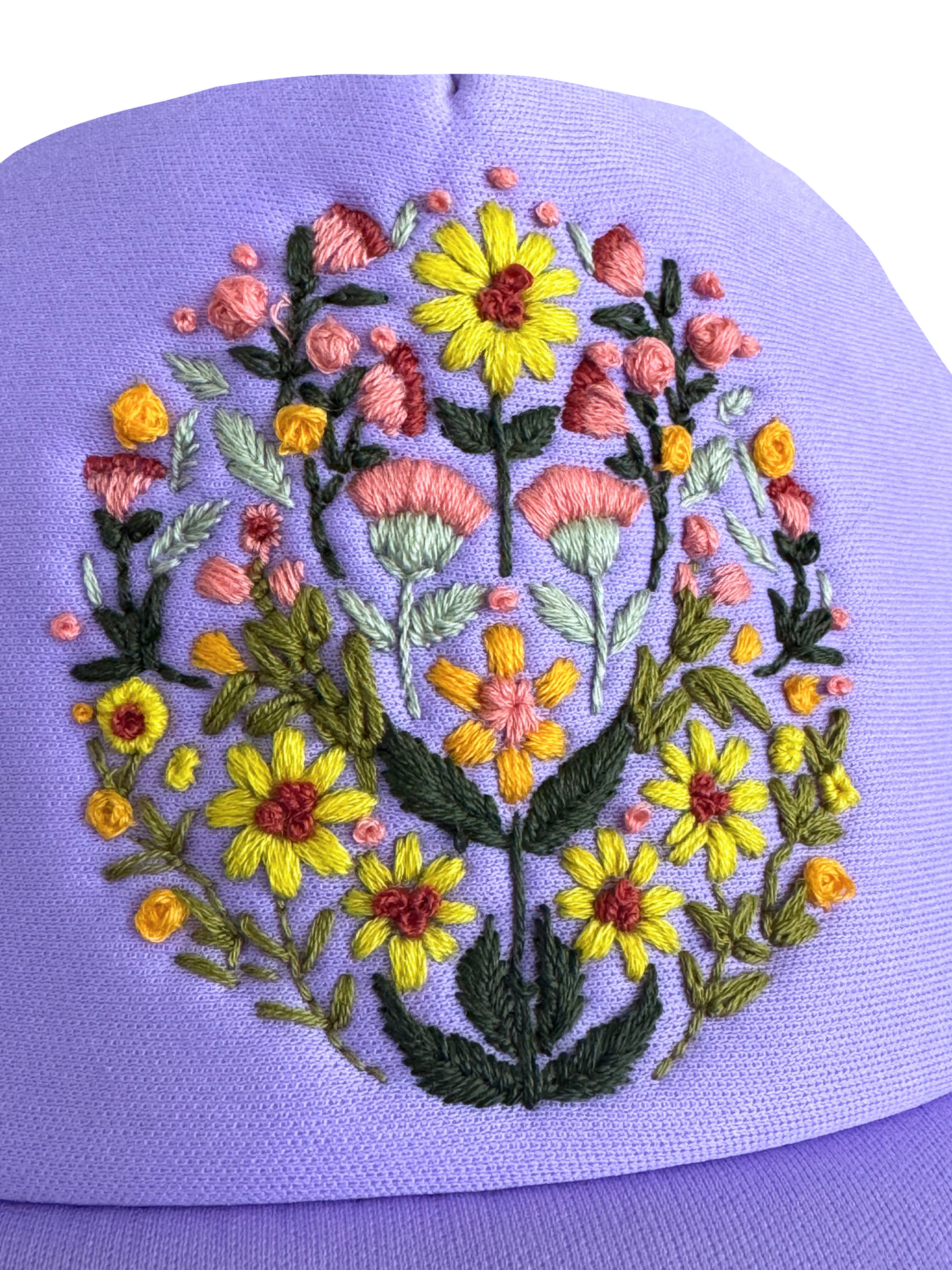 Hand-embroidered blooming garden floral design on a lavender hat.