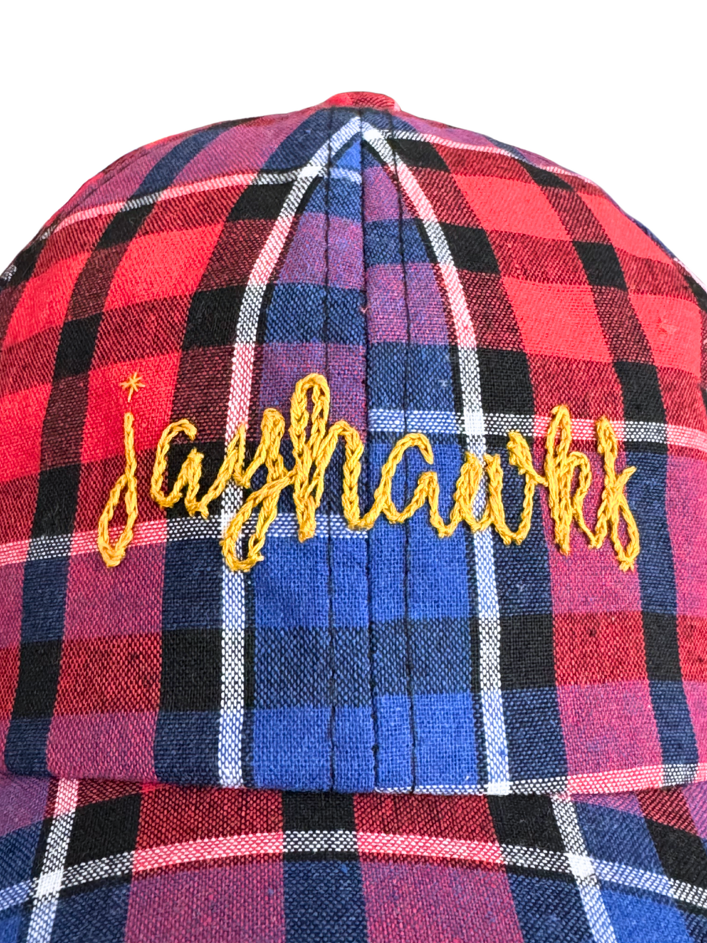 Hand-embroidered "Jayhawks" design on red and blue plaid hat.