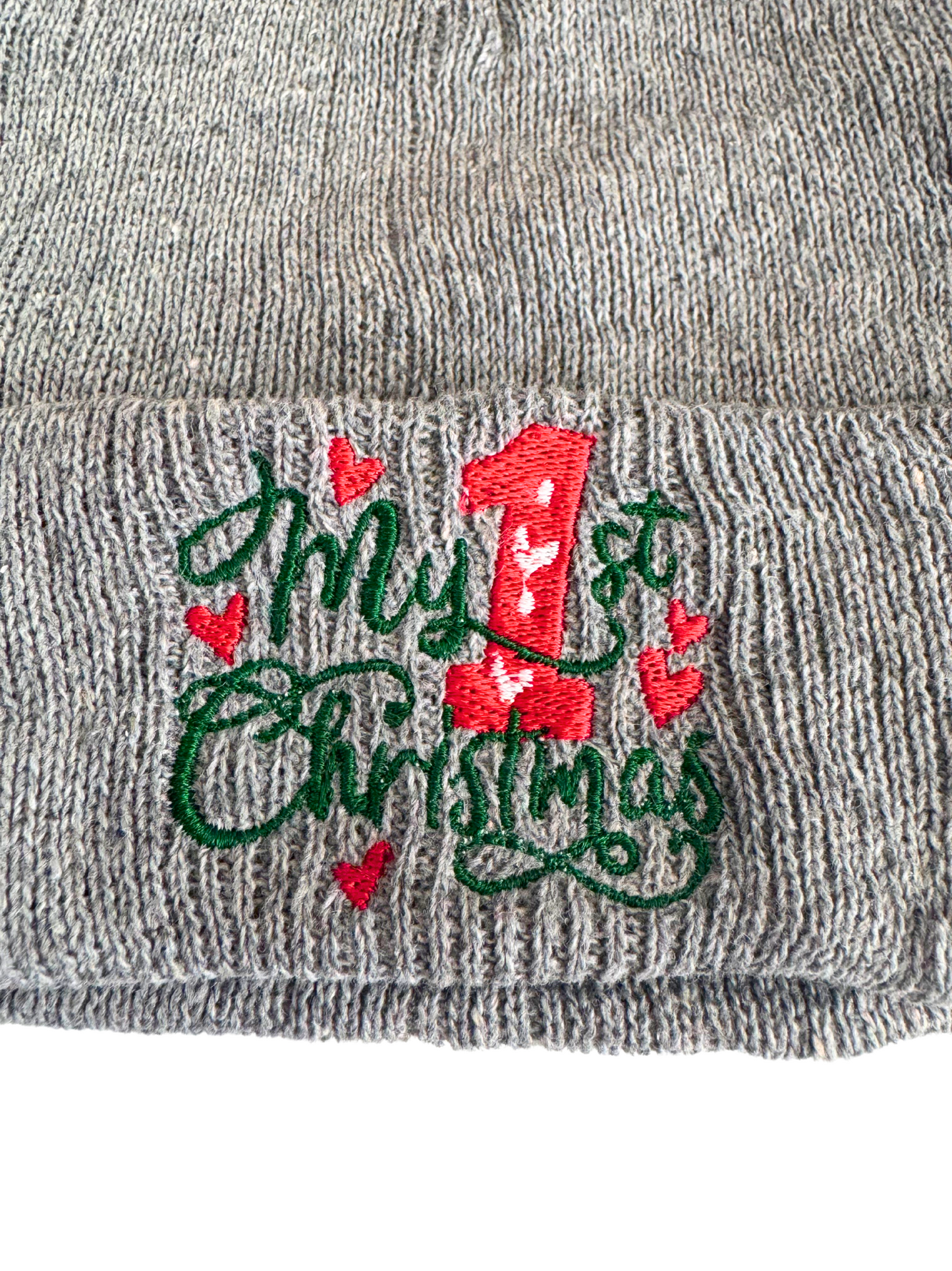 Gray baby beanie with "My 1st Christmas" embroidered in festive red and green design, featuring hearts and a large red "1."
