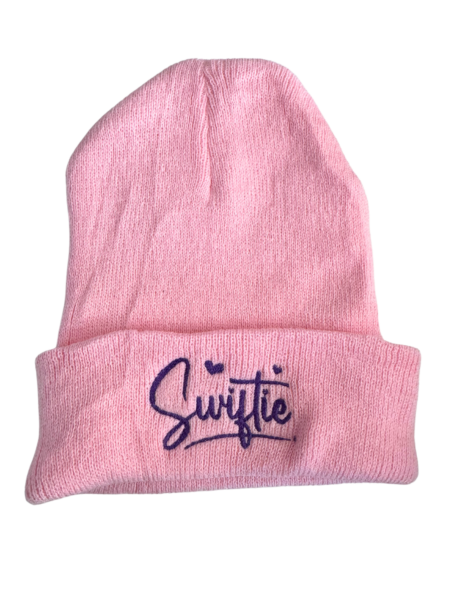 Pink beanie with "Swiftie" embroidered in purple lettering and hearts design.
