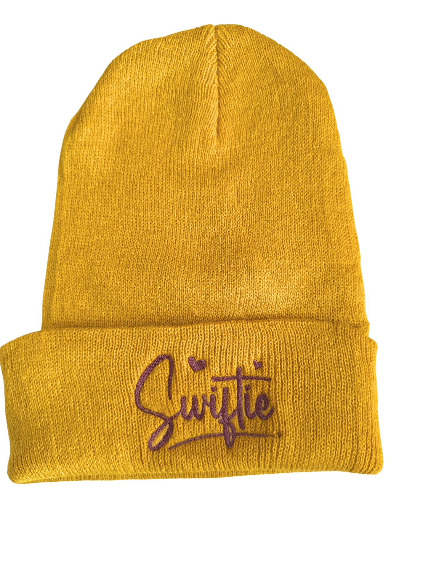 Mustard yellow beanie with purple "Swiftie" embroidery.