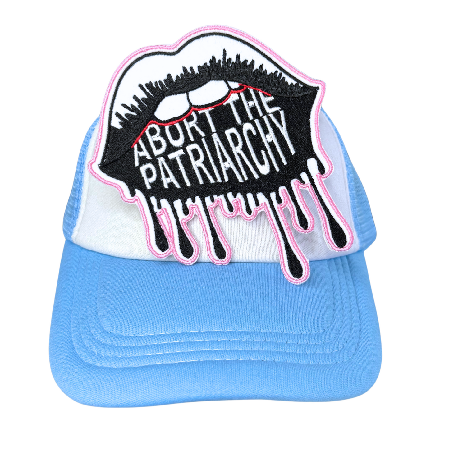 "Abort the Patriarchy" embroidered patch attached to a light blue and white trucker hat.