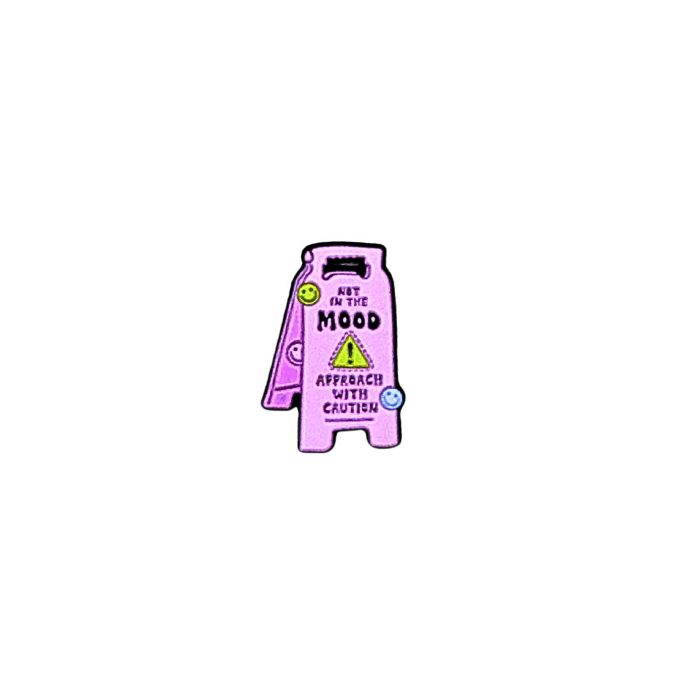 Close-up of enamel pin shaped like a pink caution sign reading “Not in the Mood / Approach With Caution”