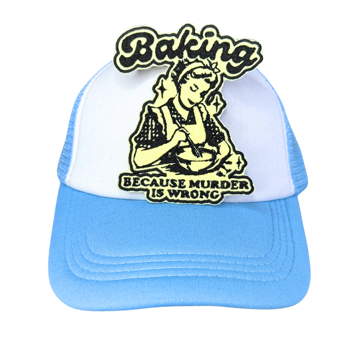 "Blue and white trucker hat with an embroidered 'Baking Because Murder is Wrong' patch in black and cream colors."