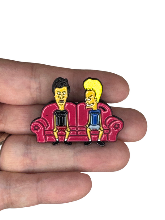 Beavis and Butt-Head pin shown in hand for scale
