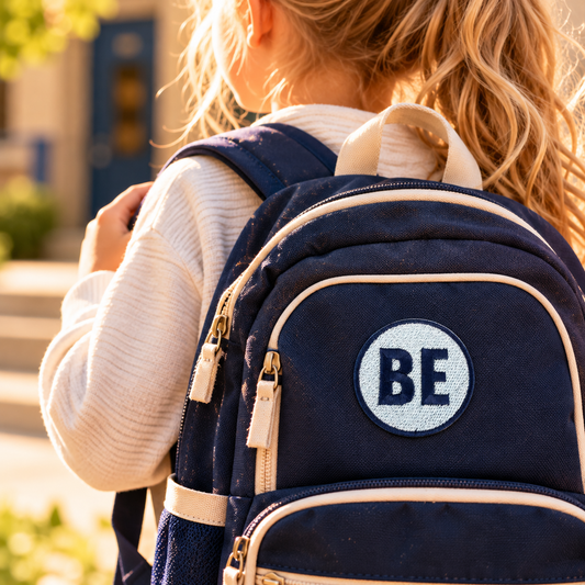 Belinder Elementary navy and white BE embroidered patch on navy backpack