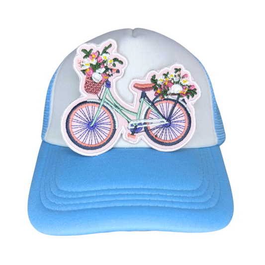 Patch shown on a blue and white trucker hat