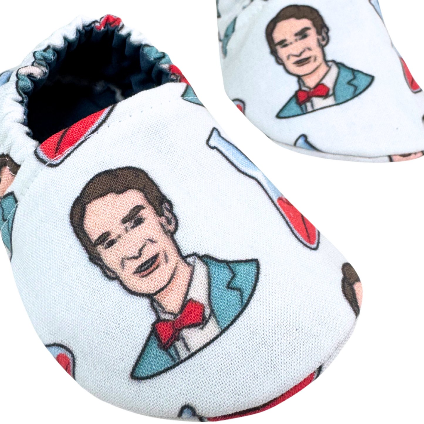 “Close-up of Bill Nye print fabric on handmade baby shoes, soft sole, 3-6 months”