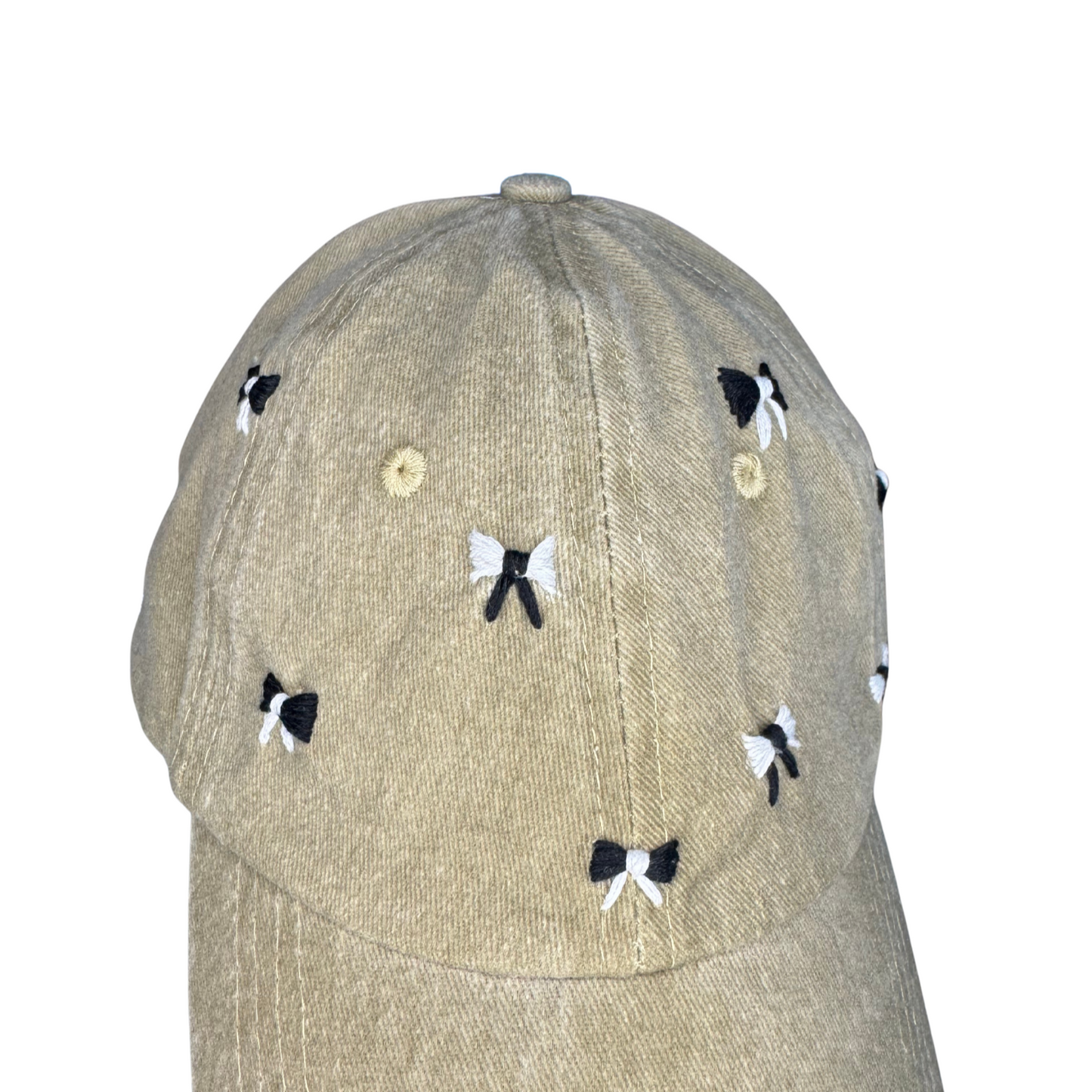 Beige cap with black and white butterfly designs on a white background