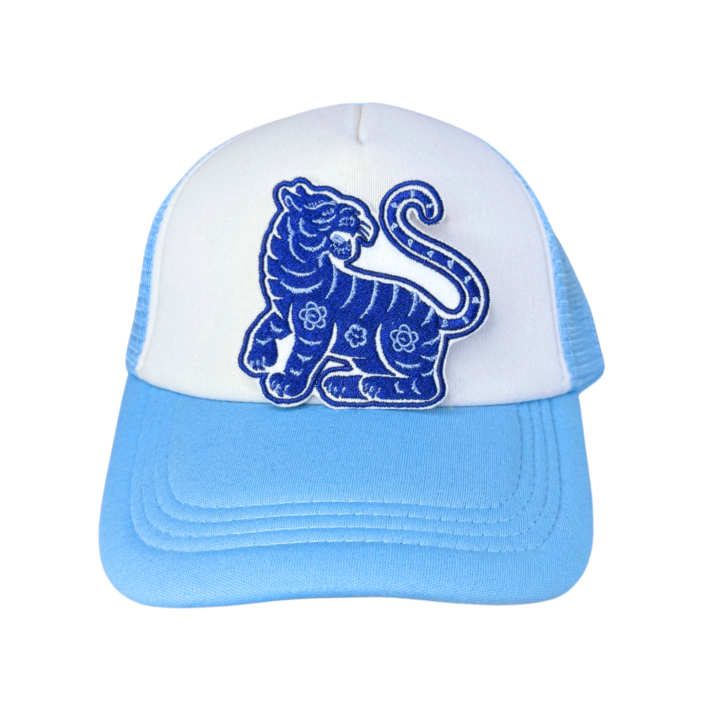 Blue Tiger embroidered patch attached to a light blue and white trucker hat.