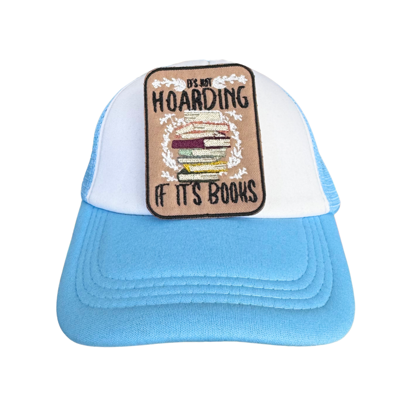 White and blue trucker hat featuring the "It's Not Hoarding If It's Books" embroidered patch, perfect for book lovers.