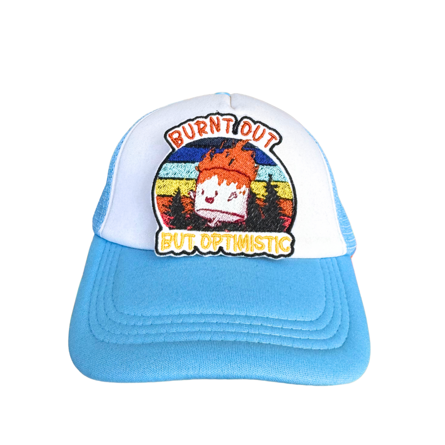 "White and blue trucker hat with a Burnt Out But Optimistic embroidered patch attached."