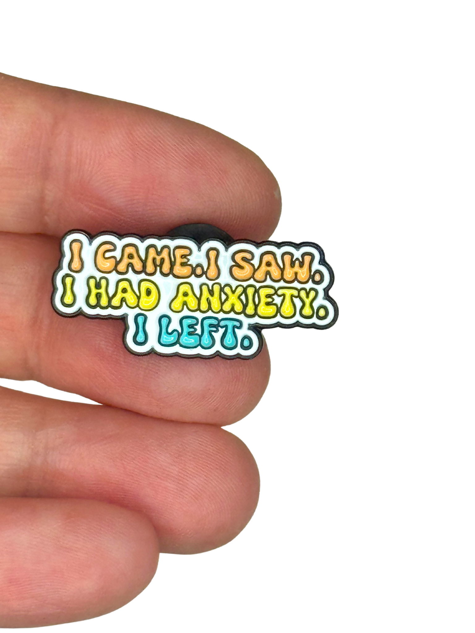 “Anxiety quote pin shown on fingers for scale”