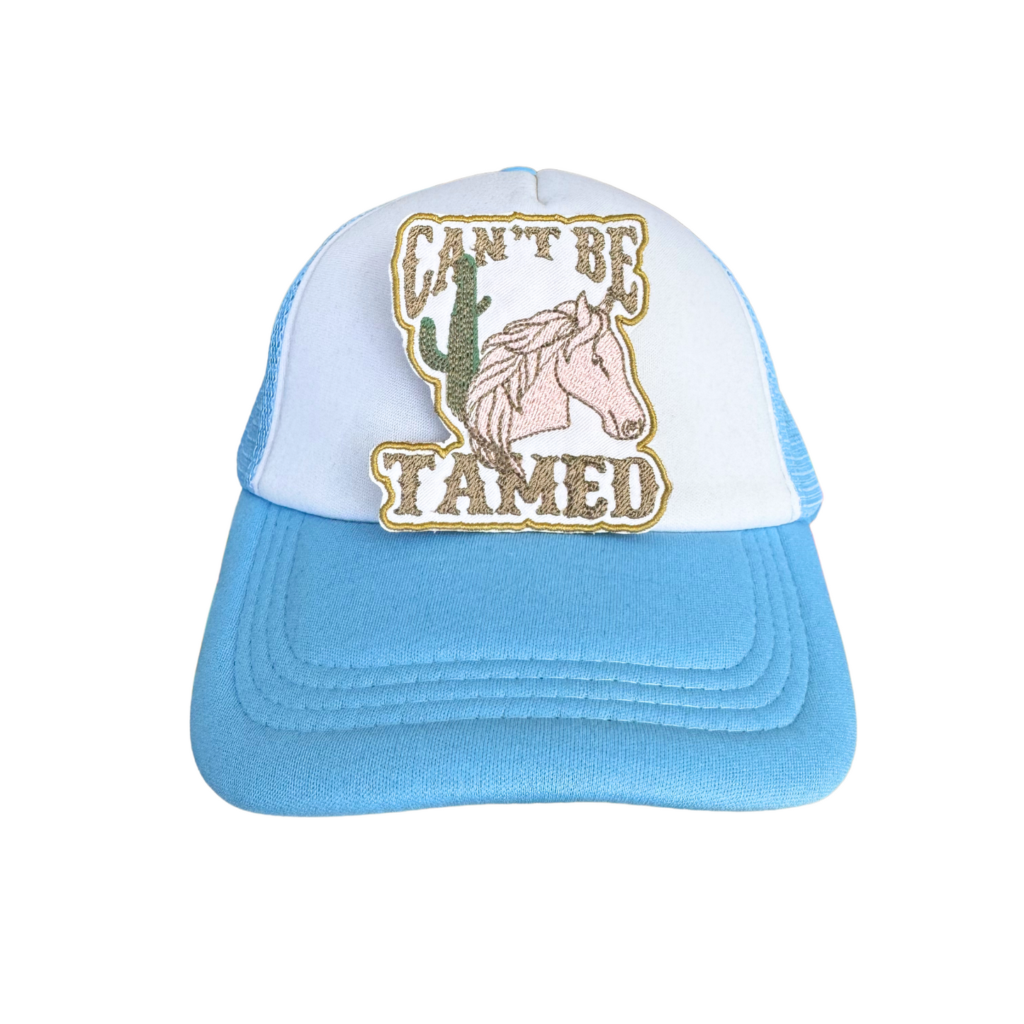 Trucker hat with "Can't Be Tamed" embroidered patch, perfect for cowgirl fashion lovers.