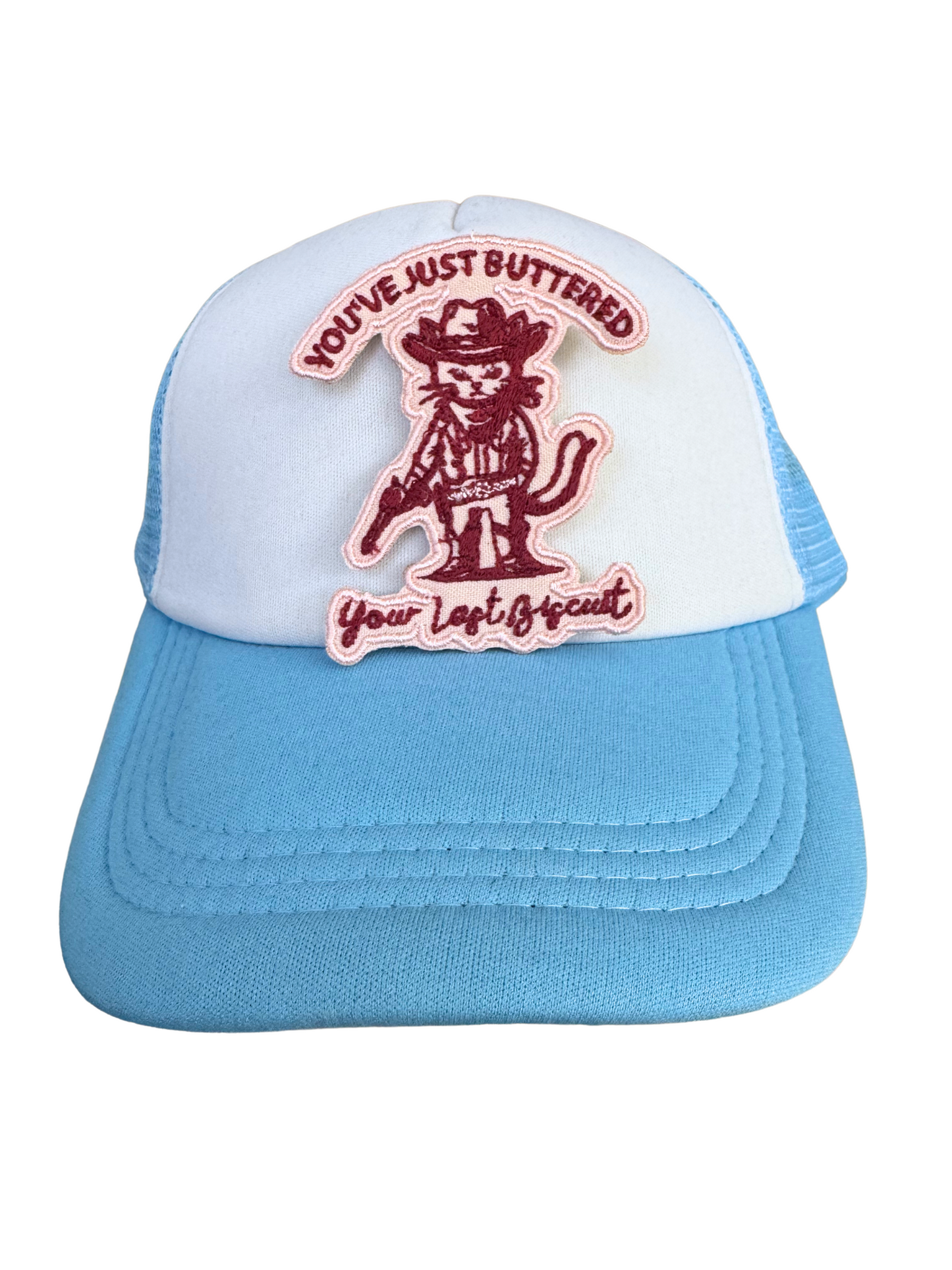 Blue and white trucker hat featuring the cowboy cat patch, ideal for lovers of quirky and Western designs.