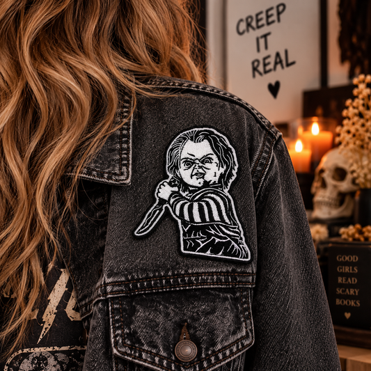 Creepy Killer Doll embroidered patch worn on a black denim jacket
