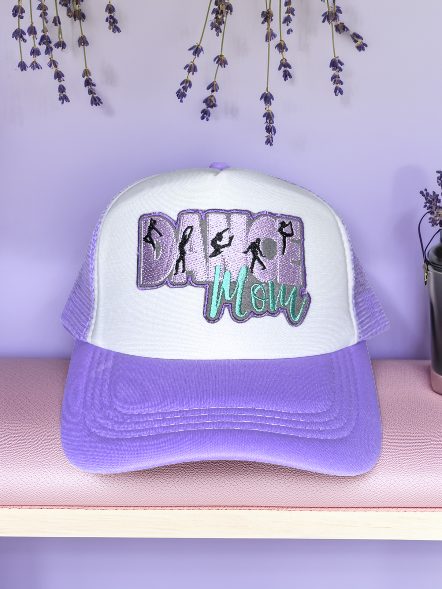 Purple and white cap with 'Dance Mom' text and dancer graphics on a light purple background.