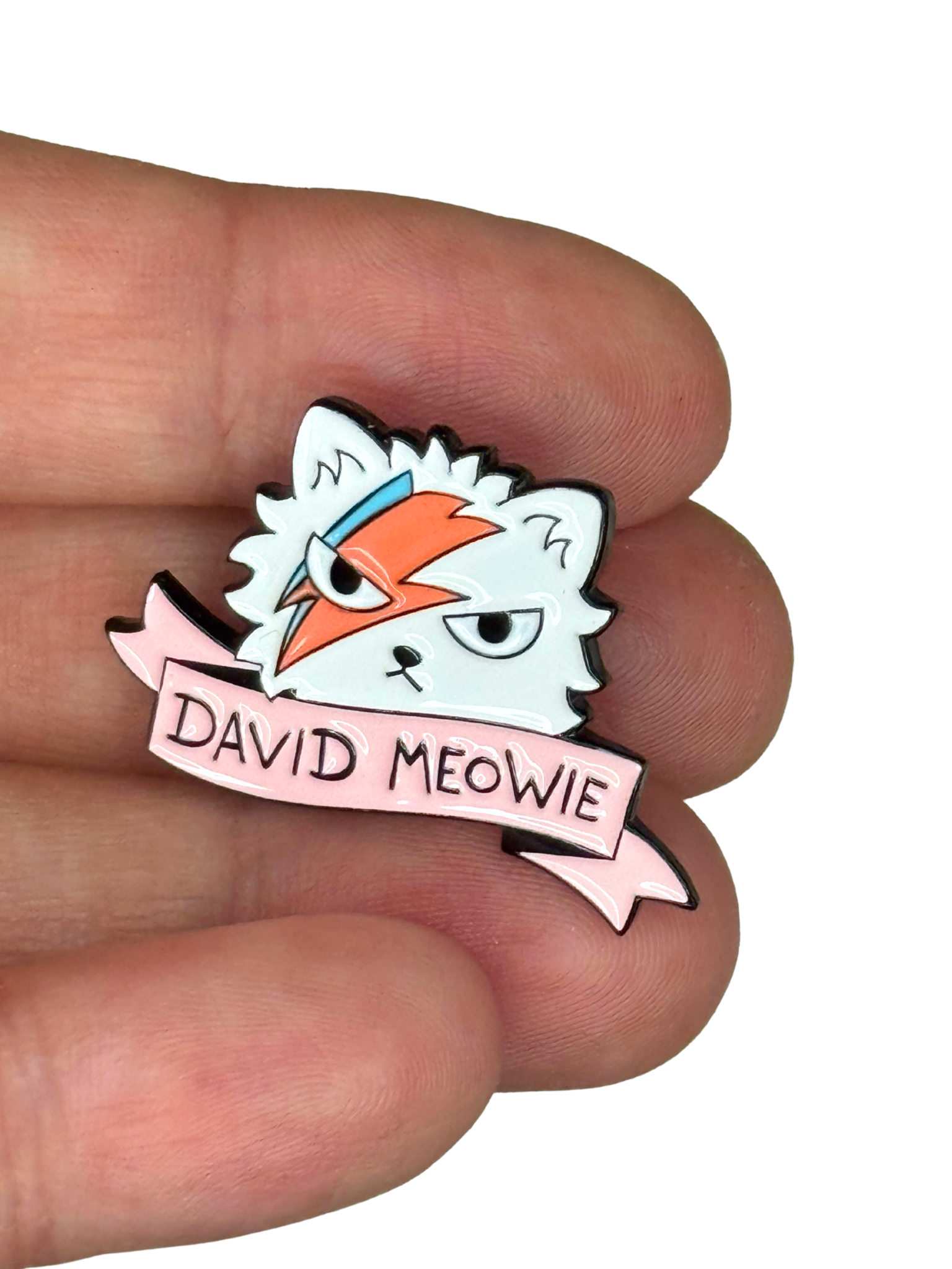 “David Meowie pin shown on fingers for scale”