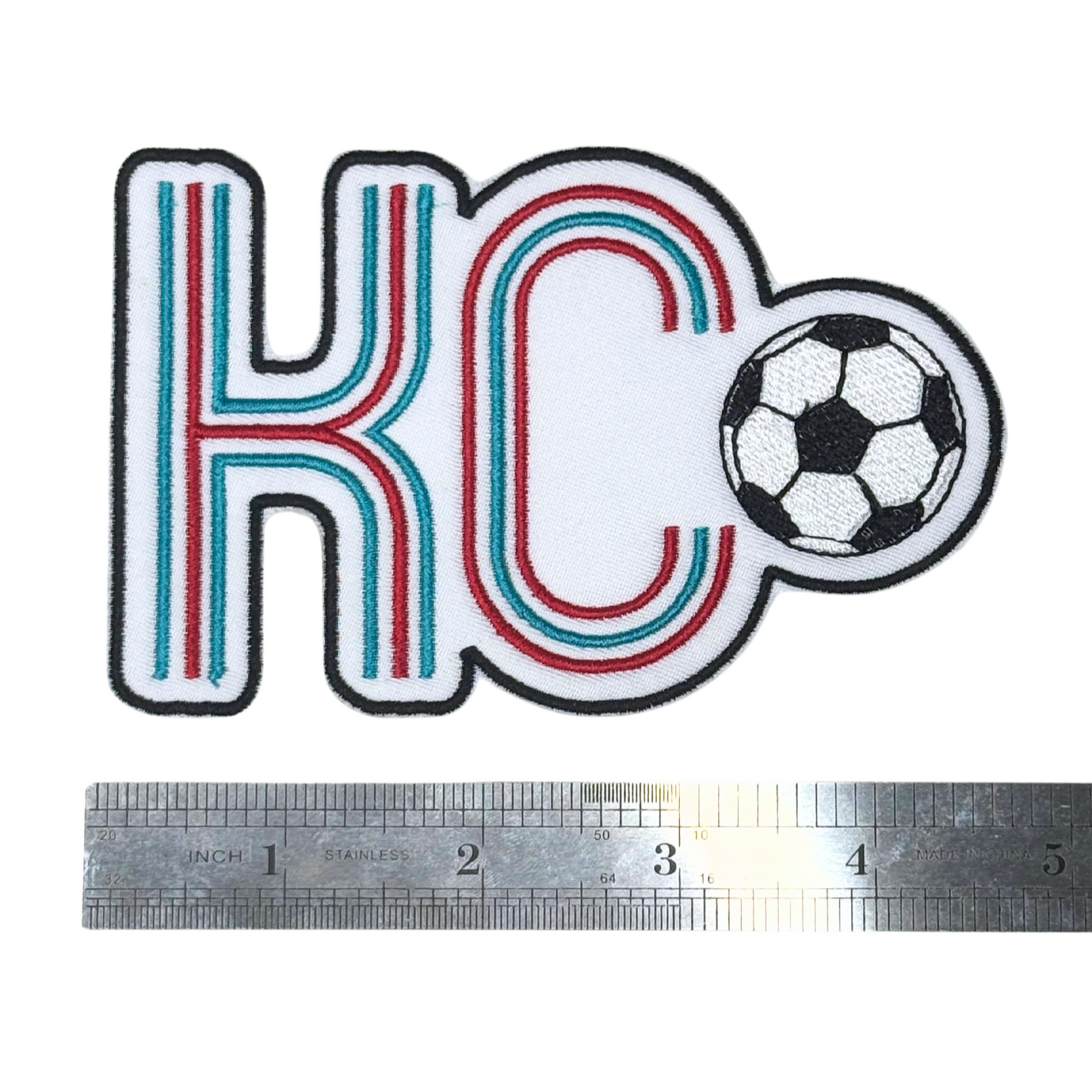 KC soccer patch next to a ruler for scale reference