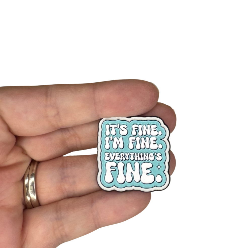 Person holding the enamel pin for size reference