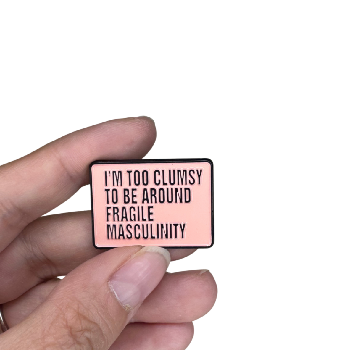 Pin shown in hand for scale, highlighting size and color