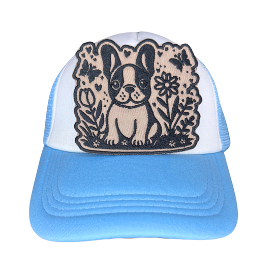 French bulldog patch staged on a straw hat with picnic background and daisies
