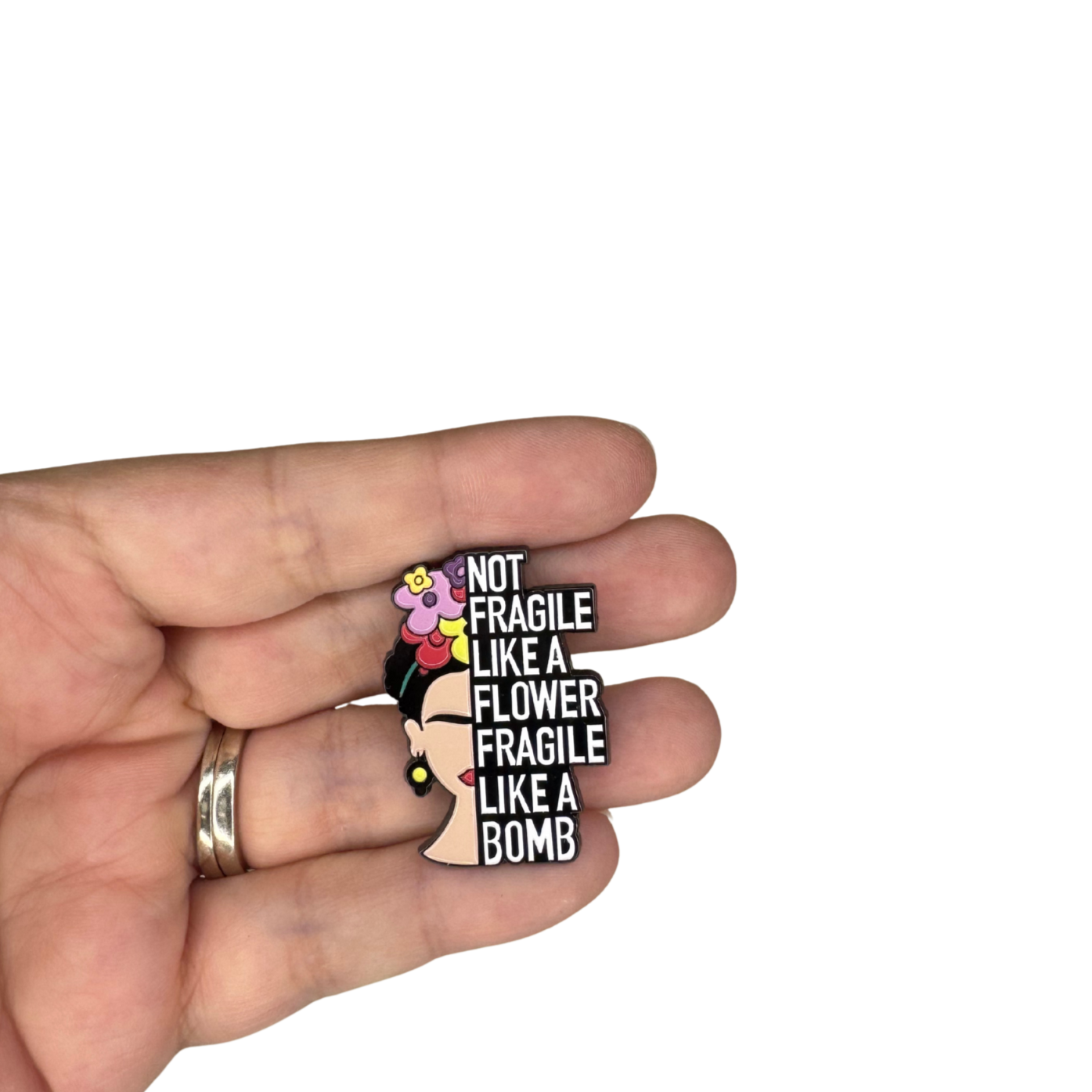Frida pin shown in hand for size reference