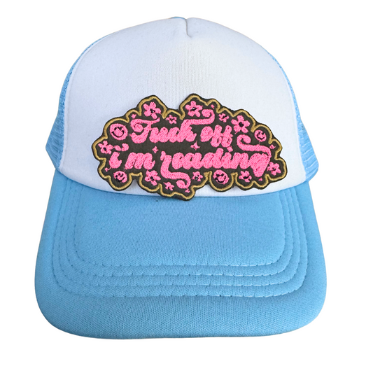 Blue and white trucker hat featuring the "Fuck Off I'm Reading" patch, handmade and styled for bold fashion.