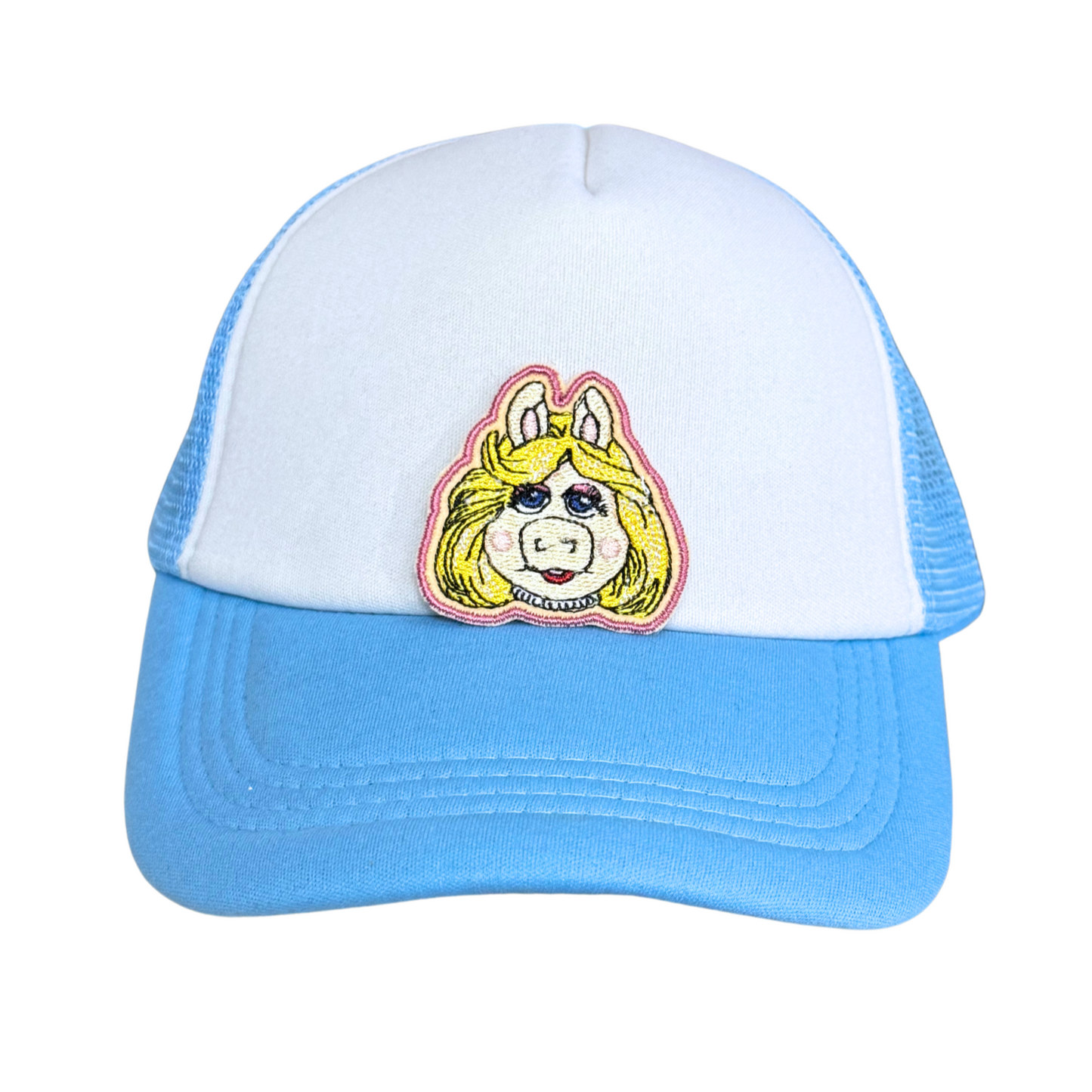 Light blue and white trucker hat with an embroidered blonde pig patch attached.