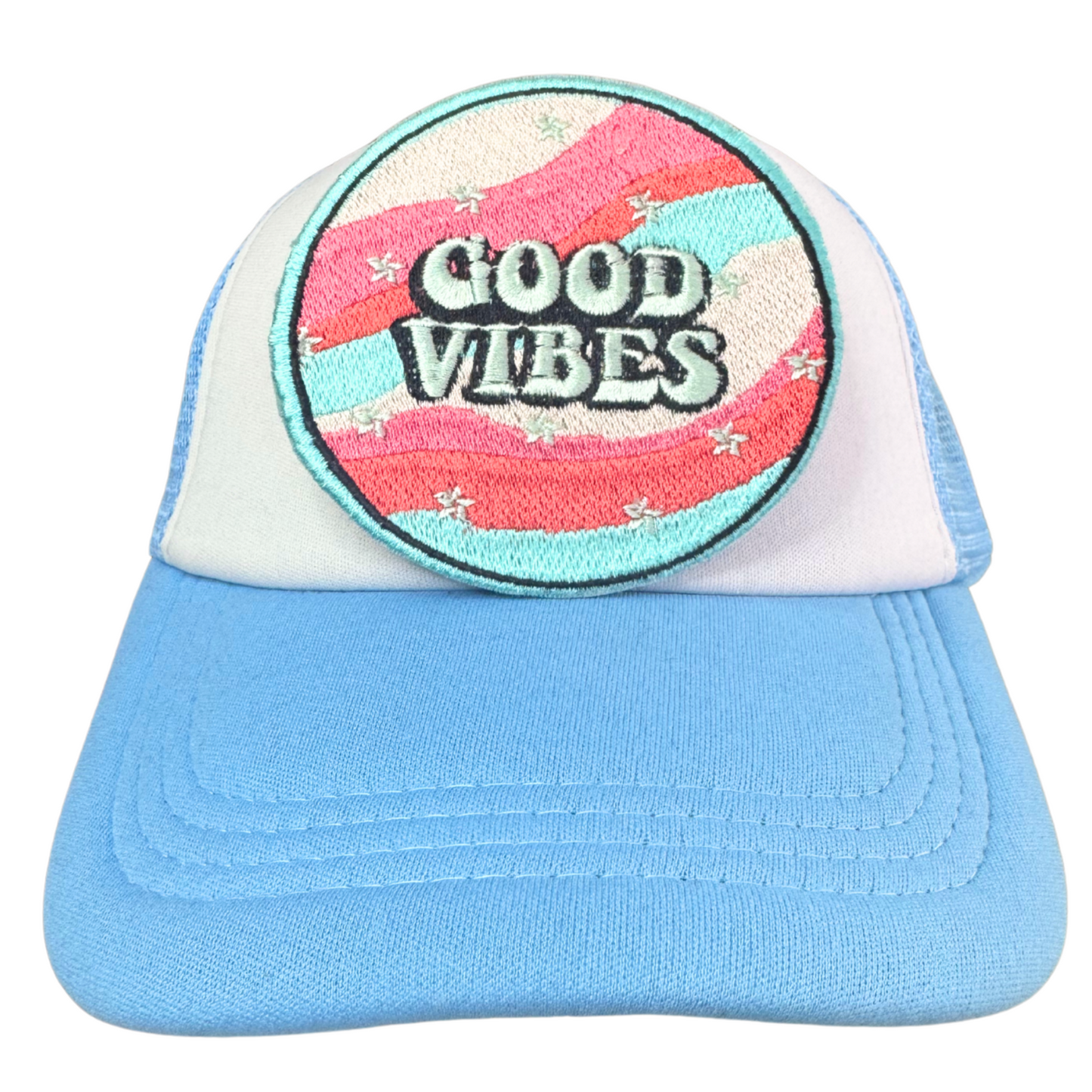 Light blue and white trucker hat with an embroidered "Good Vibes" patch attached.